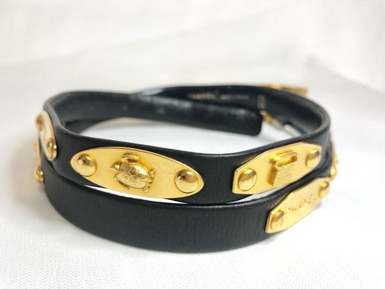 CHANEL Vintage black belt with golden buckle and iconic logo motifs, CC mark, camellia flower, turtle, perfume, clover