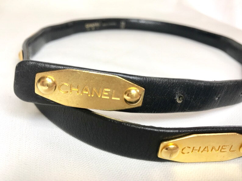 CHANEL Vintage black belt with golden buckle and iconic logo motifs, CC mark, camellia flower, turtle, perfume, clover