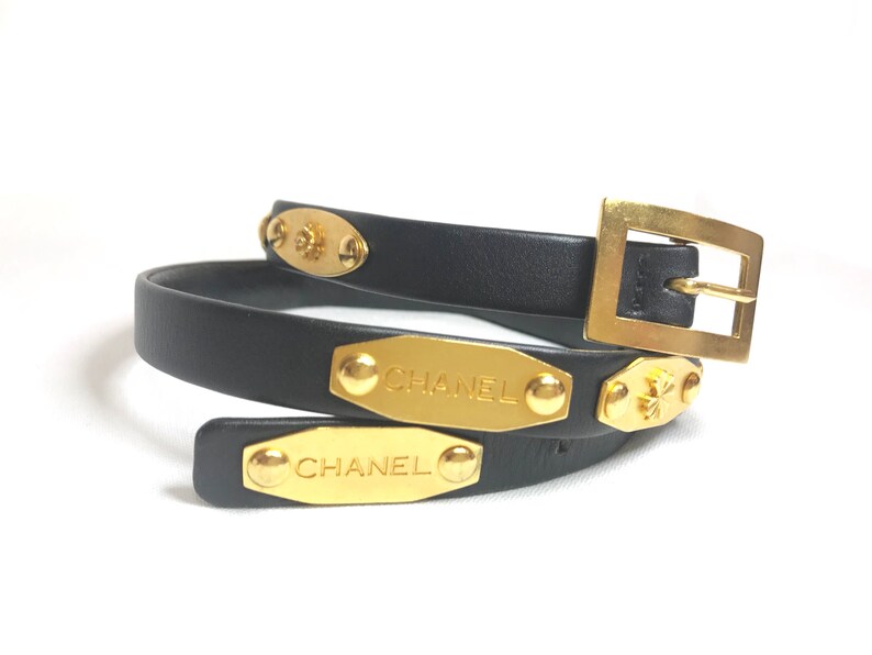 CHANEL Vintage black belt with golden buckle and iconic logo motifs, CC mark, camellia flower, turtle, perfume, clover