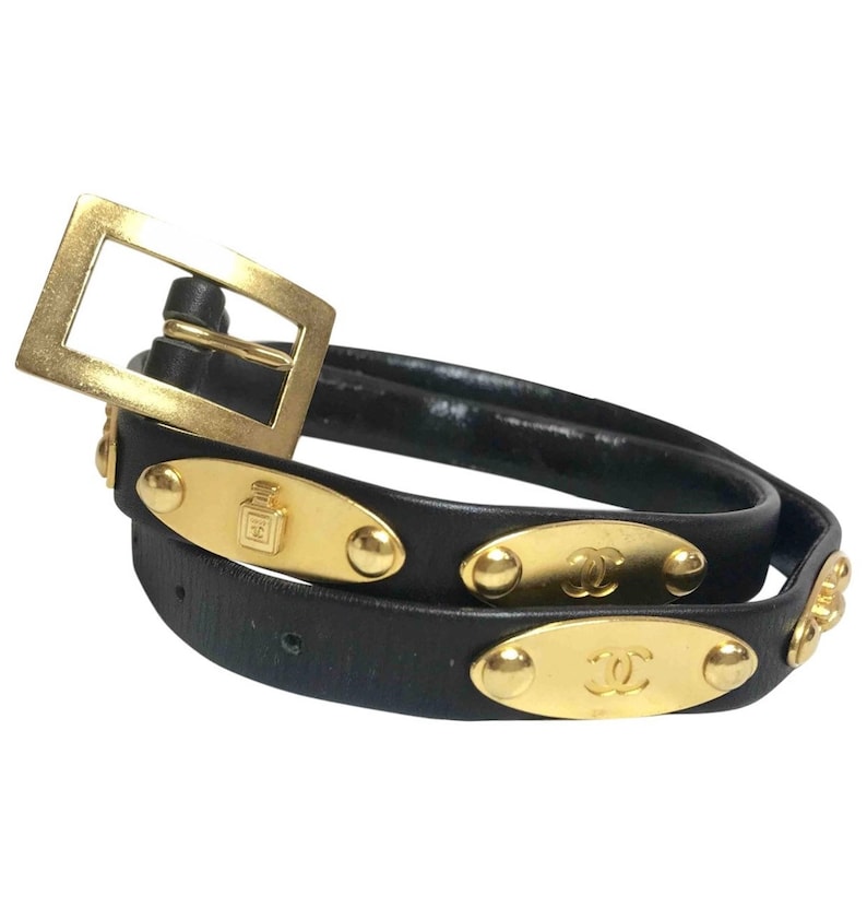 CHANEL Vintage black belt with golden buckle and iconic logo motifs, CC mark, camellia flower, turtle, perfume, clover