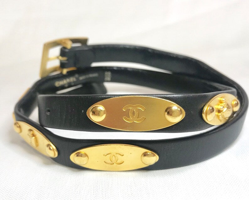 CHANEL Vintage black belt with golden buckle and iconic logo motifs, CC mark, camellia flower, turtle, perfume, clover