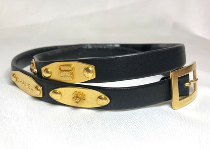 CHANEL Vintage black belt with golden buckle and iconic logo motifs, CC mark, camellia flower, turtle, perfume, clover