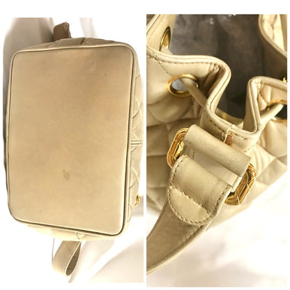 CHANEL Vintage beige quilted lamb leather hobo bucket shoulder bag with drawstrings and golden CC mark ball