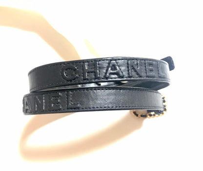 CHANEL Vintage black skinny belt with golden chain buckle and logo stitch