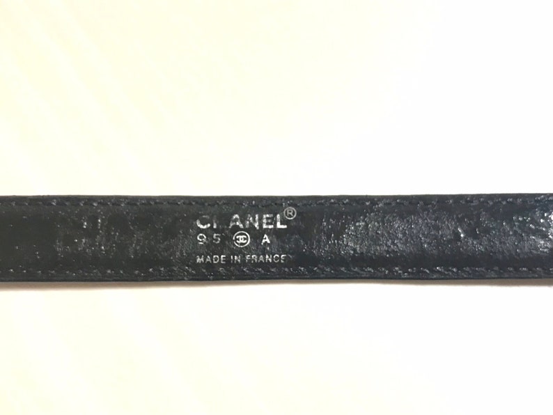 CHANEL Vintage black skinny belt with golden chain buckle and logo stitch