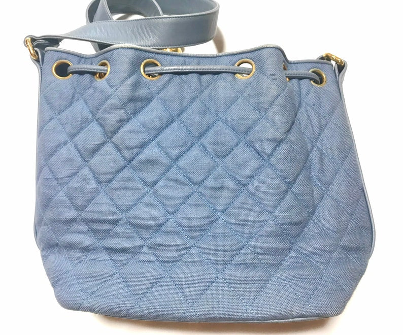 CHANEL Vintage blue quilted canvas and leather combo hobo bucket shoulder bag with drawstrings and golden CC mark balls