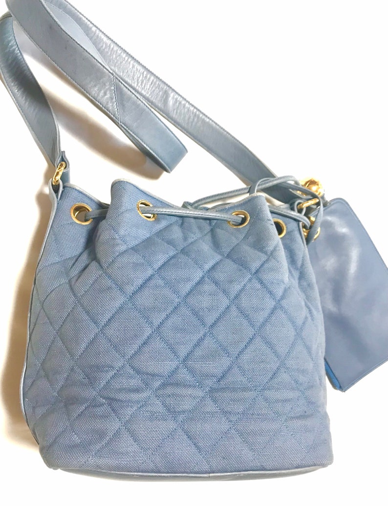 CHANEL Vintage blue quilted canvas and leather combo hobo bucket shoulder bag with drawstrings and golden CC mark balls