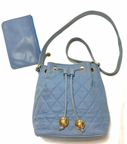 CHANEL Vintage blue quilted canvas and leather combo hobo bucket shoulder bag with drawstrings and golden CC mark balls