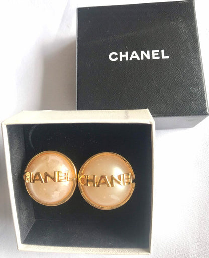 CHANEL Vintage gold tone round earrings with faux pearl and logo on it