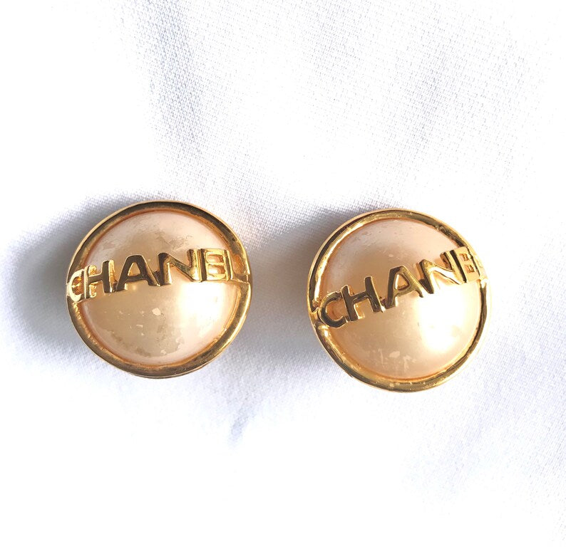 CHANEL Vintage gold tone round earrings with faux pearl and logo on it