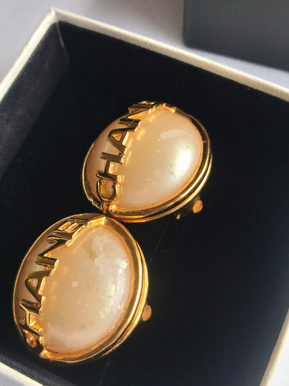 CHANEL Vintage gold tone round earrings with faux pearl and logo on it