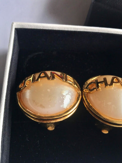 CHANEL Vintage gold tone round earrings with faux pearl and logo on it