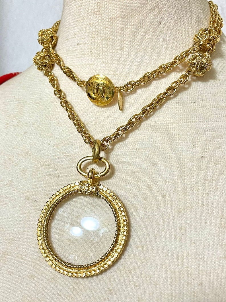 CHANEL Vintage golden chain necklace with loupe glass pendant top and ball charms