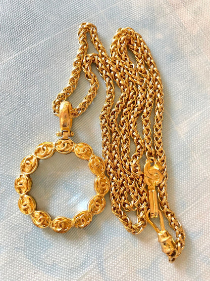 CHANEL Vintage long chain necklace with round glass loupe pendant top and CC motifs