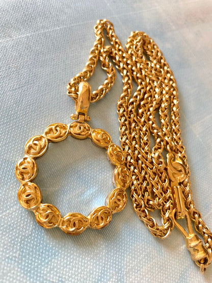 CHANEL Vintage long chain necklace with round glass loupe pendant top and CC motifs