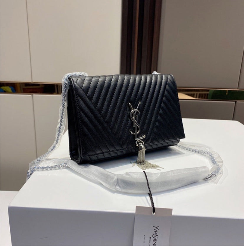 Black woman Yves Saint Laurent shoulder handbag